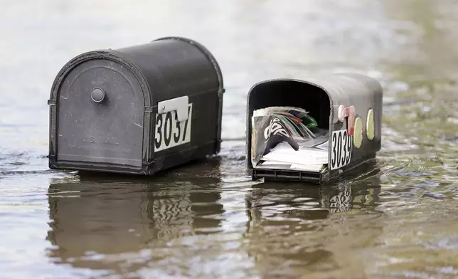 Water levels reaching mailboxes along Rose St. a community inundated by historic flooding of the Alafia River, Friday, Oct. 11, 2024 in Lithia, Fla. (Luis Santana/Tampa Bay Times via AP)