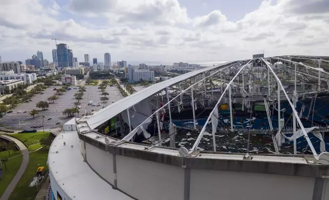 The roof of the Tropicana Field is damaged the morning after Hurricane Milton hit the region, Thursday, Oct. 10, 2024, in St. Petersburg, Fla. (AP Photo/Julio Cortez)