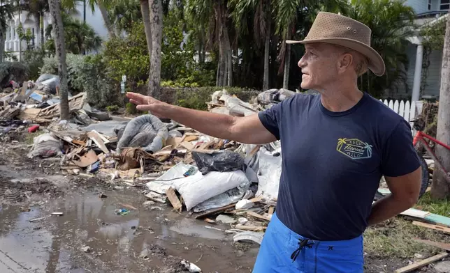 Arnie Bellini surveys the damages caused from Hurricane Helene on a street in Clearwater Beach, Fla., Tuesday, Oct. 8, 2024. Bellini fronted $500,000. of his own money to help speed up debris cleanup ahead of the possible arrival of Hurricane Milton. (AP Photo/Chris O'Meara)