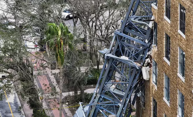 An aerial drone view of the scene where a downtown high-rise was smashed by a fallen crane from Hurricane Milton at 490 1st Avenue South, Friday, Oct. 11, 2024 in St. Petersburg, Fla. The building damaged by Hurricane Milton is home to the Tampa Bay Times, a law firm, a defense contractor and more. (Dirk Shadd/Tampa Bay Times via AP)