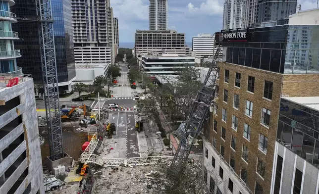 An aerial drone view of the scene where a downtown high-rise was smashed by a fallen crane from Hurricane Milton at 490 1st Avenue South, Friday, Oct. 11, 2024 in St. Petersburg, Fla. The building damaged by Hurricane Milton is home to the Tampa Bay Times, a law firm, a defense contractor and more. (Dirk Shadd/Tampa Bay Times via AP)