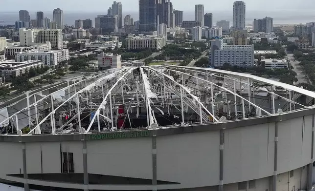 An aerial drone view shows Tropicana Field with the roof damaged after Hurricane Milton in downtown St. Petersburg, Fla., on Thursday, Oct. 10, 2024. (Dirk Shadd/Tampa Bay Times via AP)