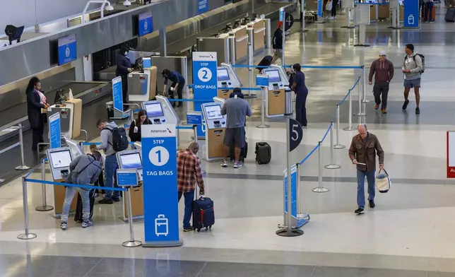 Travelers check in as flights to Tampa, Fla., are canceled due to Hurricane Milton on Wednesday, Oct. 9, 2024 at the Philadelphia International Airport. (Alejandro A. Alvarez/The Philadelphia Inquirer via AP)