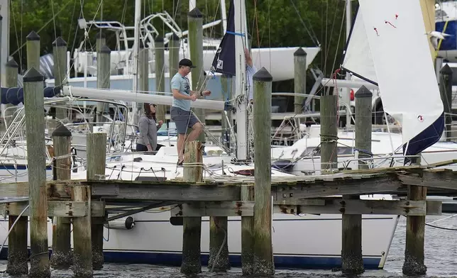 Owners try to secure their boat at the Davis Islands Yacht Clubs ahead a possible landfall by Hurricane Milton, Monday, Oct. 7, 2024, in Tampa, Fla. (AP Photo/Chris O'Meara)