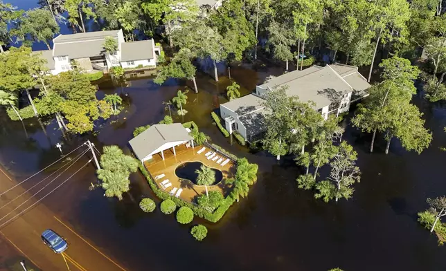 A motorist unsuccessfully tries to drive through flooding after Hurricane Milton hit the region, Thursday, Oct. 10, 2024, in Palm Harbor, Fla. (AP Photo/Mike Carlson)