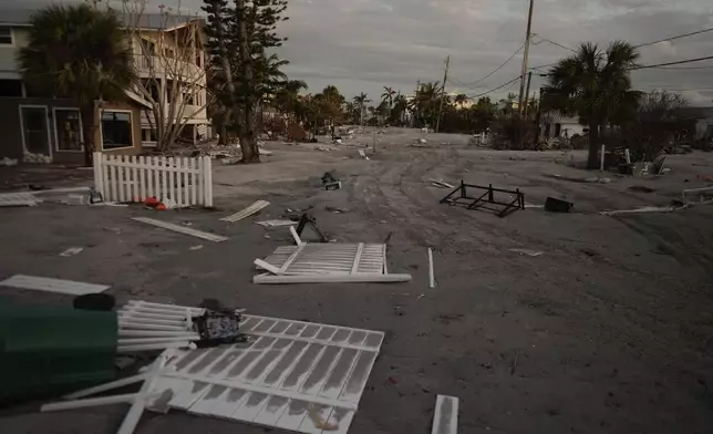 A section of the island's main road not yet reached by county work crews remains covered in feet of sand following the passage of Hurricane Milton, on Manasota Key, Fla., Saturday, Oct. 12, 2024. (AP Photo/Rebecca Blackwell)