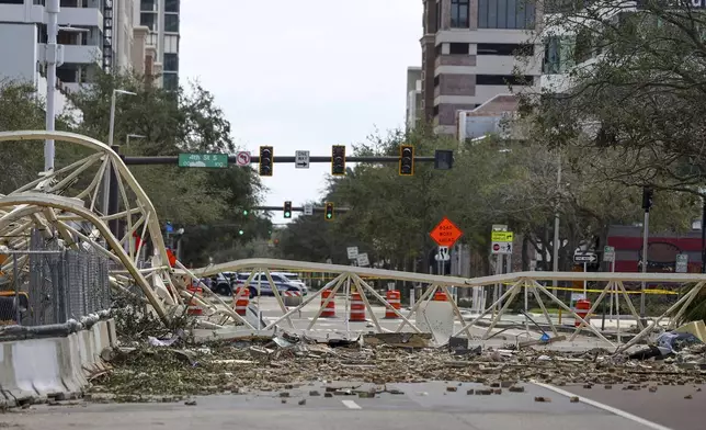 A high rise construction crane broke apart and crashed into the building across the street during Hurricane Milton on Thursday, Oct. 10, 2024, in St. Petersburg, Fla. (AP Photo/Mike Carlson)