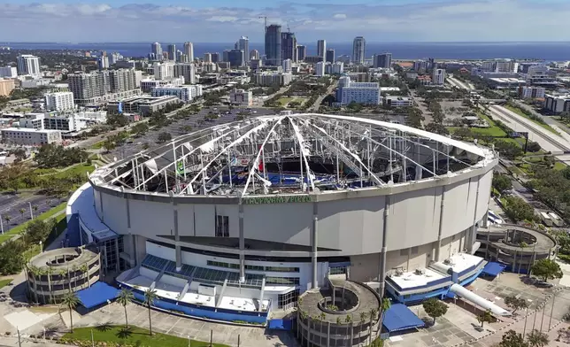 The roof of the Tropicana Field is damaged the morning after Hurricane Milton hit the region, Thursday, Oct. 10, 2024, in St. Petersburg, Fla. (AP Photo/Mike Carlson)