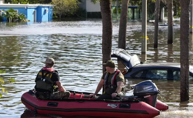 A water rescue boat moves in flood waters at an apartment complex in the aftermath of Hurricane Milton, Thursday, Oct. 10, 2024, in Clearwater, Fla. (AP Photo/Mike Stewart)