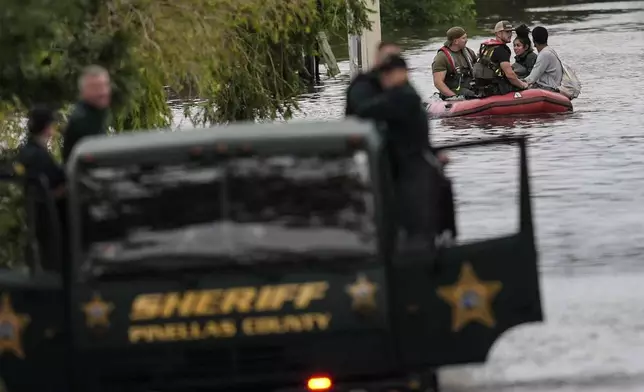 People are rescued from an apartment complex after heavy flooding in the aftermath of Hurricane Milton, Thursday, Oct. 10, 2024, in Clearwater, Fla. (AP Photo/Mike Stewart)