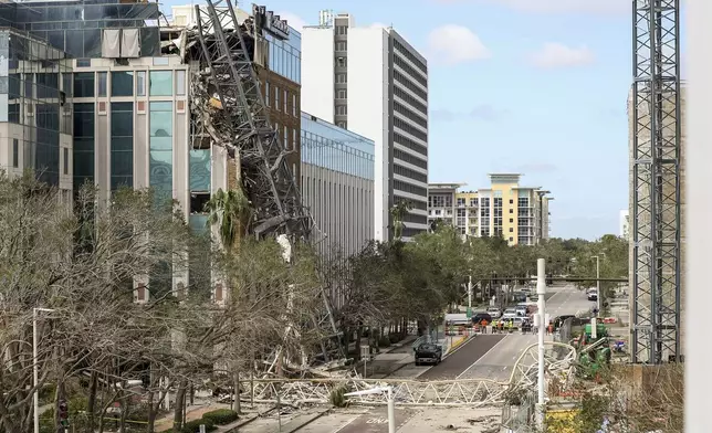 A high rise construction crane broke apart and crashed into the building across the street during Hurricane Milton on Thursday, Oct. 10, 2024, in St. Petersburg, Fla. (AP Photo/Mike Carlson)