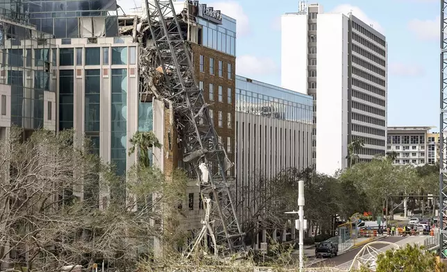 A high rise construction crane broke apart and crashed into the building across the street during Hurricane Milton on Thursday, Oct. 10, 2024, in St. Petersburg, Fla. (AP Photo/Mike Carlson)