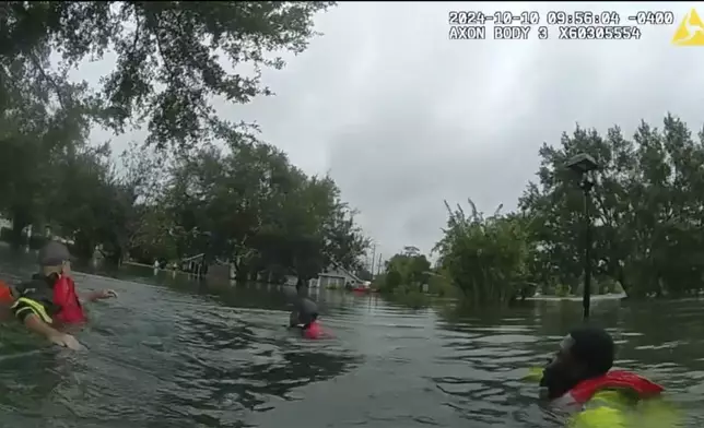 This image taken from Deland Police bodycam shows DeLand police and fire crews conduct water rescues after Hurricane Milton on Thursday, Oct. 10, 2024 in DeLand, Fla. (City of DeLand, Fla., via AP)