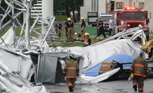 FILE - Firefighters investigate the collapsed canopy that covered the Dallas Cowboys indoor football facility in Irving, Texas, May 2, 2009. (AP Photo/File)