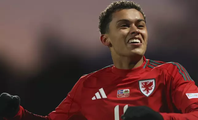 Brennan Johnson of Wales celebrates after scoring the opening goal during the UEFA Nations League group 4 soccer match between Iceland and Wales in Reykjavik, Iceland, Friday, Oct. 11, 2024. (AP Photo/Arni Torfason)