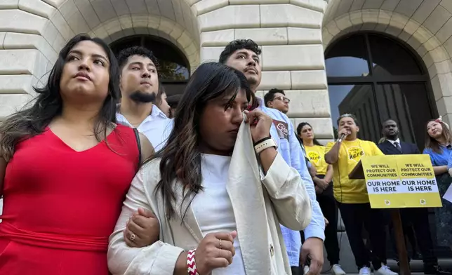 Wendy Reynoso, 24, whose DACA application remains in limbo, wipes away tears at a rally outside a federal appeals court in New Orleans on Thursday, Oct. 10, 2024, in a hearing to decide the future of the policy. (AP Photo/Jack Brook)