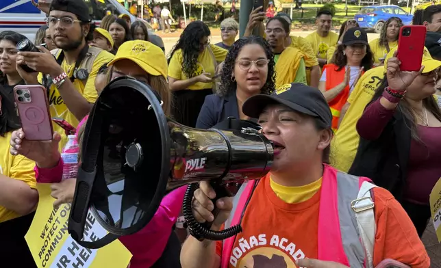 DACA supporter Claudia Valdivia wields a megaphone at a rally outside federal appeals court in New Orleans on Thursday, Oct. 10 ,2024. (AP Photo/Jack Brook)