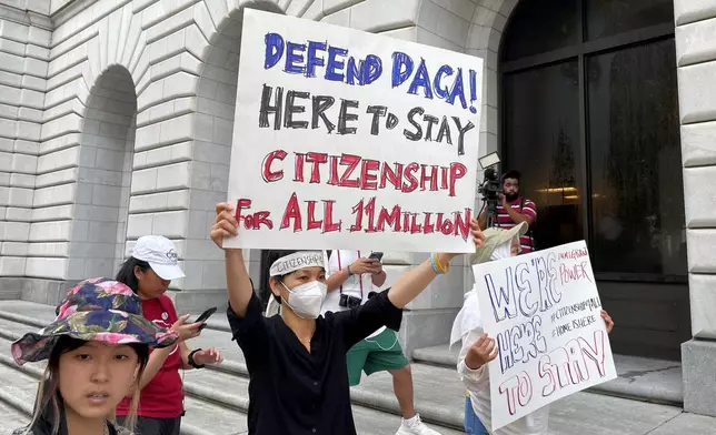 FILE - Demonstrators hold up signs outside the 5th U.S. Circuit Court of Appeals building in New Orleans on July 6, 2022. (AP Photo/Kevin McGill, file)