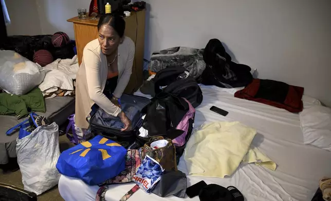 Sofia Roca, an immigrant from Colombia, packs up her belongings in Aurora, Colorado, on March 29, 2024, as she prepares to leave in search of work in another state. (AP Photo/Thomas Peipert)