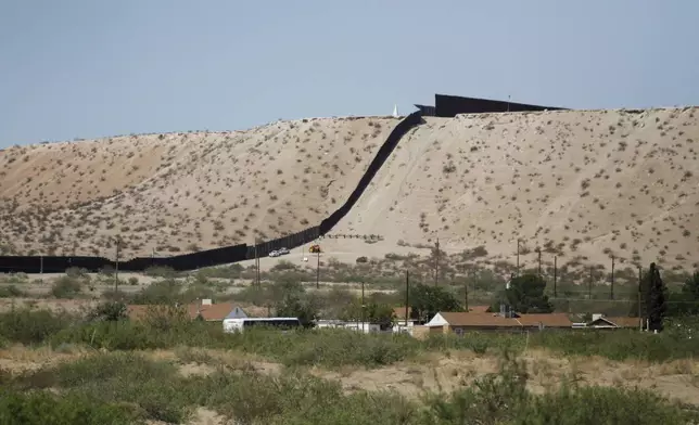 Border Patrol vehicles survey a steel fence at the Southwest border with Mexico at Sunland Park, N.M., Thursday, Aug. 22, 2024. (AP Photo/Morgan Lee, File)