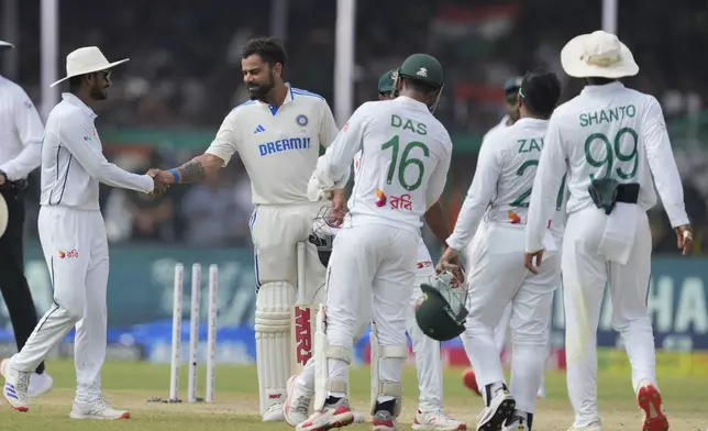 Bangladesh's players congratulate India's Virat Kohli, second left, after India won the match on the fifth and final day of the second cricket test match against Bangladesh in Kanpur, October 1, 2024. (AP Photo/Ajit Solanki)