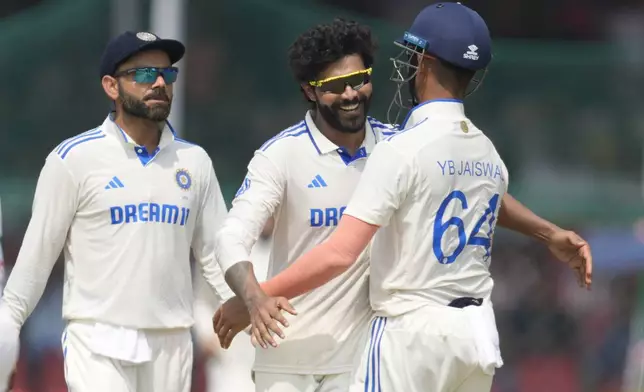 India's Ravindra Jadeja, left, Yashasvi Jaiswal, right and Virat Kohli celebrates the wicket of Bangladesh's Shakib Al Hasan on the fifth and final day of the second cricket test match between Bangladesh and India in Kanpur, India, Tuesday, October 1, 2024. (AP Photo/Ajit Solanki)