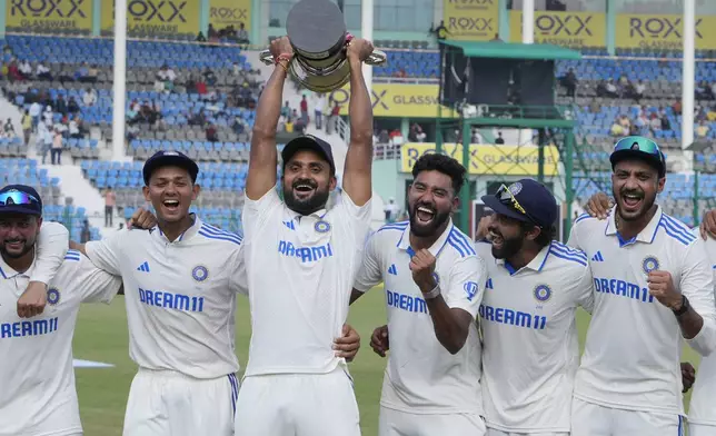 Indian players celebrate with the trophy after winning the two test match series against Bangladesh in Kanpur, India, Tuesday, October. 1, 2024. (AP Photo/Ajit Solanki)