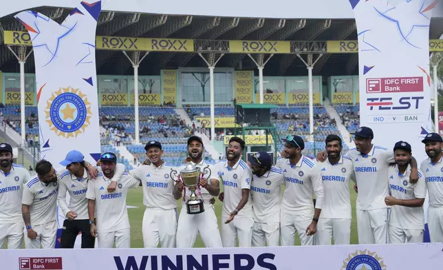 Indian players celebrate with the trophy after winning the two match test series against Bangladesh in Kanpur, India, Tuesday, October 1, 2024. (AP Photo/Ajit Solanki)