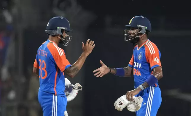 India's Hardik Pandya, right, and teammate Nitish Kumar Reddy celebrate India's win in the first T20 cricket match against Bangladesh in Gwalior, India, Sunday, Oct. 6, 2024. (AP Photo/Manish Swarup)