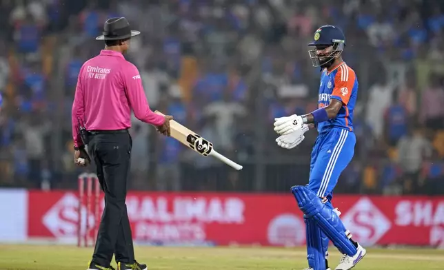 India's Hardik Pandya walks to collect his bat from the umpire after it slipped from his hands while he was playing a shot during the first T20 cricket match between Bangladesh and India in Gwalior, India, Sunday, Oct. 6, 2024. (AP Photo/Manish Swarup)