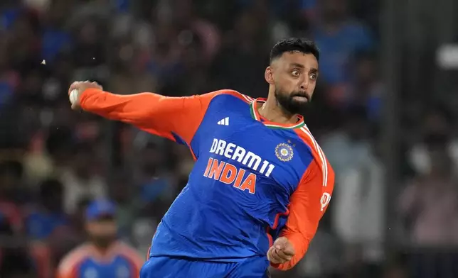 India's Varun Chakravarthy bowls a delivery during first T20 cricket match between India and Bangladesh in Gwalior, India, Sunday, Oct. 6, 2024 (AP Photo/ Manish Swarup)