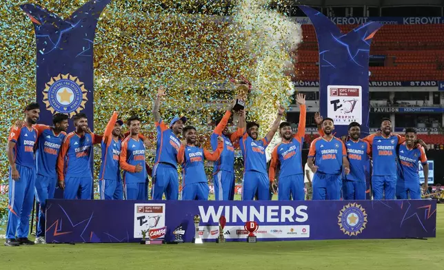 Indian players celebrate with the trophy after winning the T20 cricket series against Bangladesh in Hyderabad, India, Saturday, Oct. 12, 2024. (AP Photo/Mahesh Kumar A.)