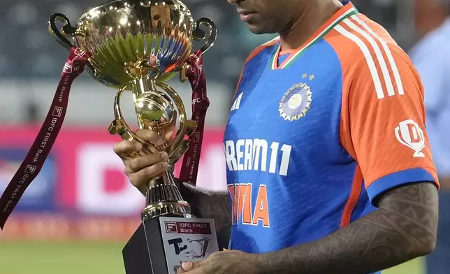 Indian captain Suryakumar Yadav holds the trophy after winning the T20 cricket series against Bangladesh in Hyderabad, India, Saturday, Oct. 12, 2024. (AP Photo/Mahesh Kumar A.)