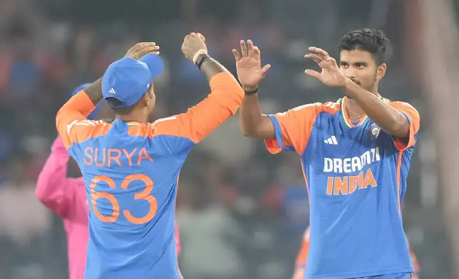 India's Washington Sunder, right, celebrates with captain Suryakumar Yadav the wicket of Bangladesh's Tanzid Hasan Tamim during the third and final T20 cricket match between Bangladesh and India in Hyderabad, India, Saturday, Oct. 12, 2024. (AP Photo/Mahesh Kumar A.)