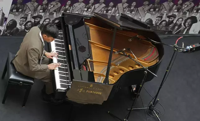 Takosangba Jamir, 27, a blind pianist, performs at a shopping mall during the two-day Brillante Piano Festival in Bengaluru, India, Sunday, Sept. 29, 2024. (AP Photo/Aijaz Rahi)