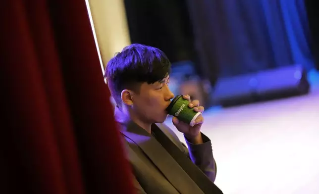 Takosangba Jamir, 27, a blind pianist, drinks tea as he waits for his turn to rehearse during the two-day Brillante Piano Festival in Bengaluru, India, Sunday, Sept. 29, 2024. (AP Photo/Aijaz Rahi)