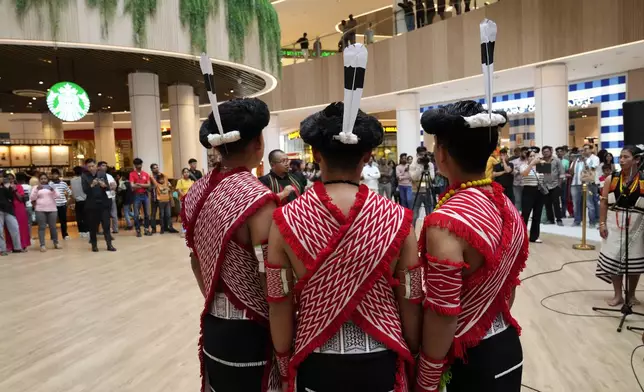 Artists from India's northeastern state of Nagaland wearing traditional attire perform at a shopping mall during the two-day Brillante Piano Festival in Bengaluru, India, Sunday, Sept. 29, 2024. (AP Photo/Aijaz Rahi)