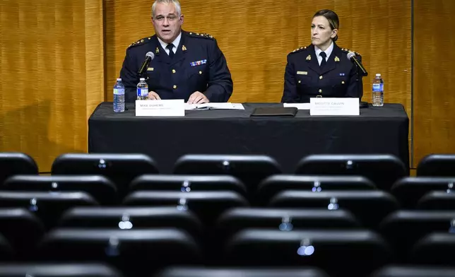 RCMP Commissioner Mike Duheme, left, and Assistant Commissioner Brigitte Gauvin participate in a news conference at RCMP National Headquarters in Ottawa, Ontaio, Monday, Oct. 14, 2024. (Justin Tang/The Canadian Press via AP)