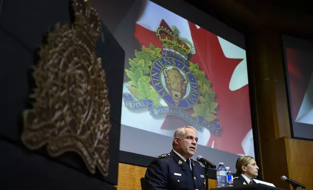 RCMP Commissioner Mike Duheme, left, and Assistant Commissioner Brigitte Gauvin participate in a news conference at RCMP National Headquarters in Ottawa, Ontaio, Monday, Oct. 14, 2024. (Justin Tang/The Canadian Press via AP)