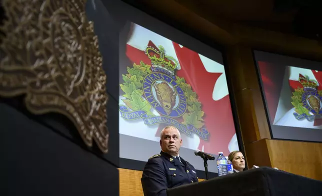 RCMP Commissioner Mike Duheme, left, and Assistant Commissioner Brigitte Gauvin participate in a news conference at RCMP National Headquarters in Ottawa, Ontaio, Monday, Oct. 14, 2024. (Justin Tang/The Canadian Press via AP)