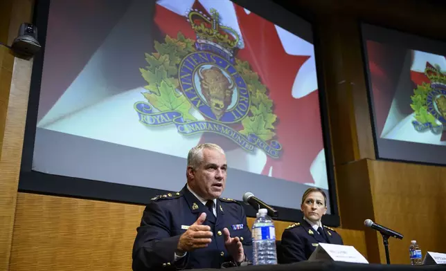 RCMP Commissioner Mike Duheme, left, and Assistant Commissioner Brigitte Gauvin participate in a news conference at RCMP National Headquarters in Ottawa, Ontaio, Monday, Oct. 14, 2024. (Justin Tang/The Canadian Press via AP)