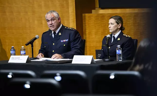 RCMP Commissioner Mike Duheme, left, and Assistant Commissioner Brigitte Gauvin participate in a news conference at RCMP National Headquarters in Ottawa, Ontaio, Monday, Oct. 14, 2024. (Justin Tang/The Canadian Press via AP)