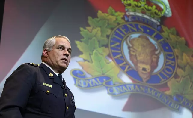 RCMP Commissioner Mike Duheme departs at the end of a news conference at RCMP National Headquarters in Ottawa, Ontaio, Monday, Oct. 14, 2024. (Justin Tang/The Canadian Press via AP)