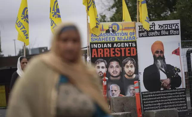 A photograph of late temple president Hardeep Singh Nijjar, back right, is displayed outside the Guru Nanak Sikh Gurdwara Sahib in Surrey, British Columbia, Tuesday, Oct. 15, 2024. (Darryl Dyck/The Canadian Press via AP)