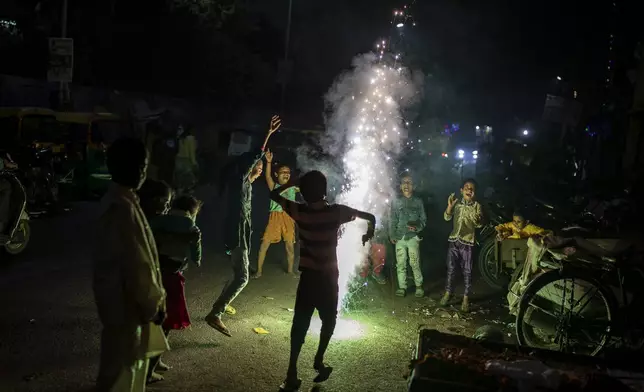 FILE- Children play with firecrackers during Diwali celebrations in New Delhi, India, Nov. 4, 2021. (AP Photo/Altaf Qadri, File)