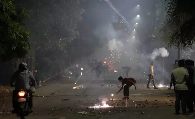 FILE- People lights firecrackers to celebrate Diwali, the festival of lights, in Ahmedabad, India, Oct. 24, 2022. (AP Photo/Ajit Solanki, File)