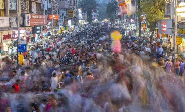 FILE- People crowd a market as they shop ahead of Diwali festival in Mumbai, India, Nov. 5, 2023. (AP Photo/Rafiq Maqbool, File)