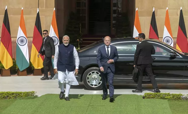 Indian Prime Minister Narendra Modi, left, and German Chancellor Olaf Scholz walk together after the latter arrived for talks in New Delhi, India, Friday, Oct. 25, 2024. (AP Photo)