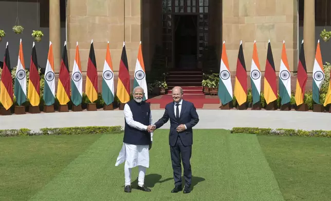 Indian Prime Minister Narendra Modi, left, and German Chancellor Olaf Scholz shake hands after the latter arrived for talks in New Delhi, India, Friday, Oct. 25, 2024. (AP Photo)