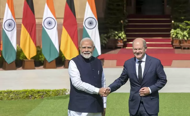 Indian Prime Minister Narendra Modi, left, and German Chancellor Olaf Scholz shake hands after the latter arrived for talks in New Delhi, India, Friday, Oct. 25, 2024. (AP Photo)